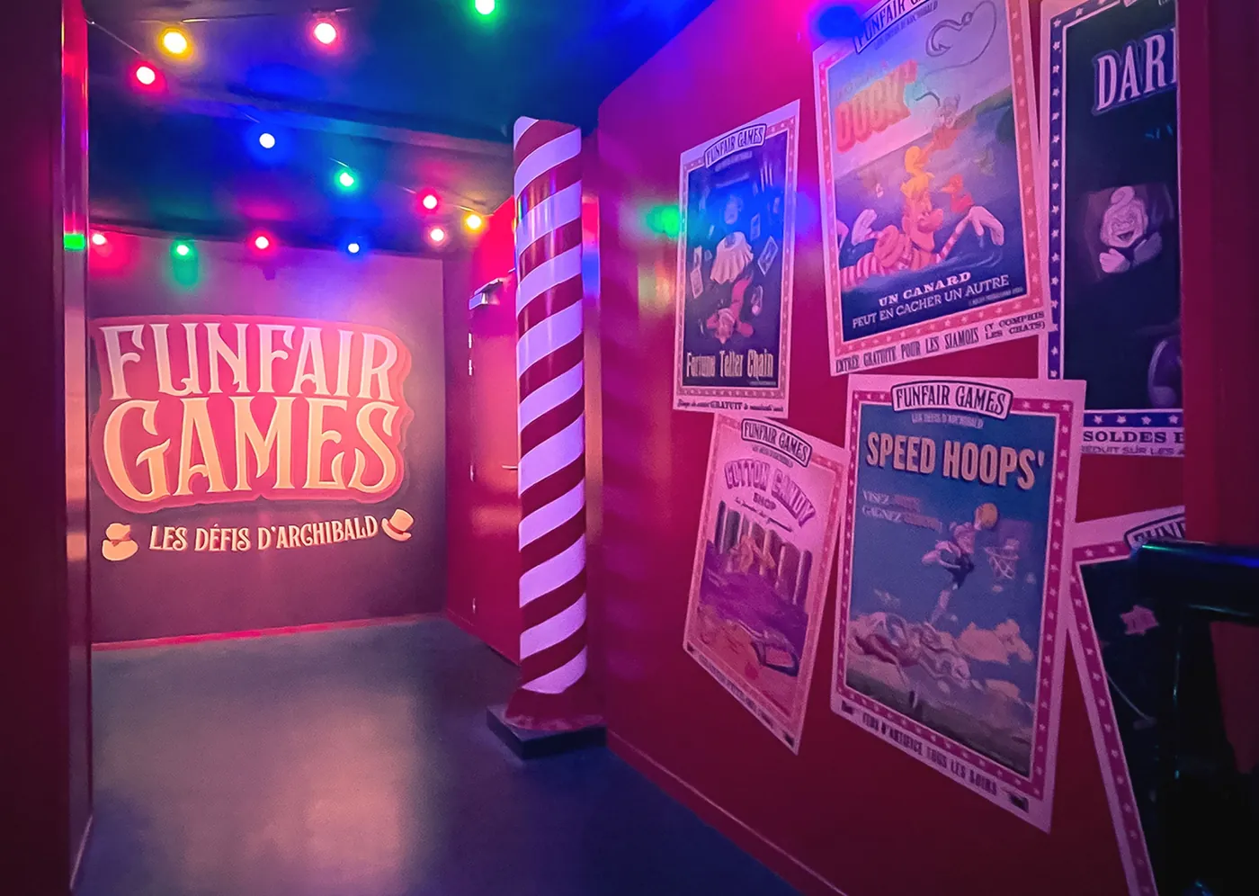 Immersive Funfair Games room with vintage attraction posters under fairground lighting.